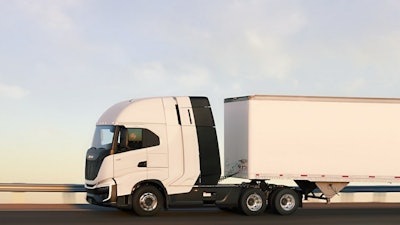 A white truck and trailer going down the road.