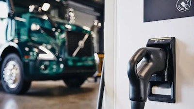 Volvo truck sitting in front of a charger