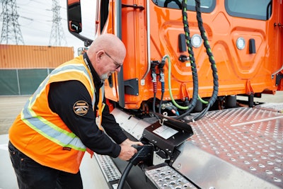 eCascadia driver at a charging station