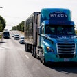A hydrogen Hyzon-branded truck drives down the road.