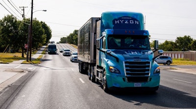 A hydrogen Hyzon-branded truck drives down the road.