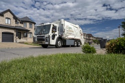 Mack LR Electric truck parked outside a private home.