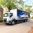 A Kenworth K270E Battery-Electric Cabover parked outside a home.