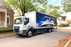 A Kenworth K270E Battery-Electric Cabover parked outside a home.
