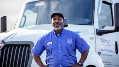 Walmart driver poses in front of his truck