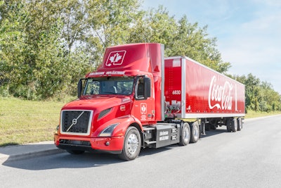 Coke-branded Volvo VNR Electric driving