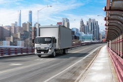 Isuzu's NRR-EV truck on highway in a city