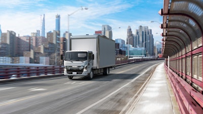Isuzu's NRR-EV truck on highway in a city