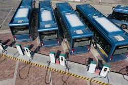 Electric transit buses parked and charging