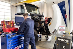 A mechanic working on a truck.