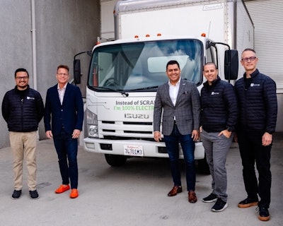 Five men stand in front of an electric Isuzu truck.