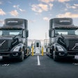 A pair of EV semis charge