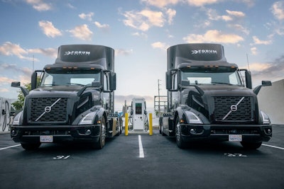 A pair of EV semis charge