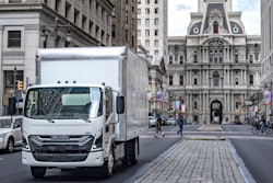 A truck driving down a city street.