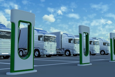 EV commercial trucks lined up for charging