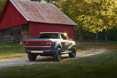 Scout Terra rear with lights on by red barn