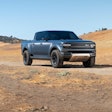 bluish gray Scout Terra pickup truck front sideview in desert