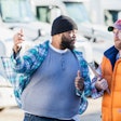 Two men frustratedly discussing a used truck sale