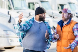 Two men frustratedly discussing a used truck sale