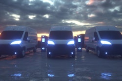 A rendering of battery-electric commercial vans parked at charging stations.