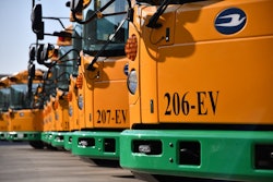 Blue Bird RE Electric school buses lined up in a parking lot.