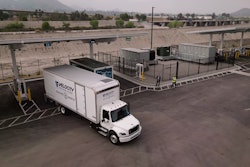 A truck from Velocity Truck Centers is show pulling out of an Greenlane EV charging terminal.