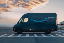 A Rivian EDV with the Amazon logo parked outside a warehouse.