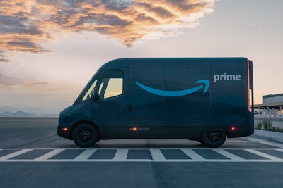 A Rivian EDV with the Amazon logo parked outside a warehouse.