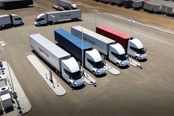 A rendering of Tesla Semis hauling Uber Freight trailers at Megawatt charging stations.