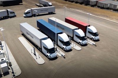 A rendering of Tesla Semis hauling Uber Freight trailers at Megawatt charging stations.