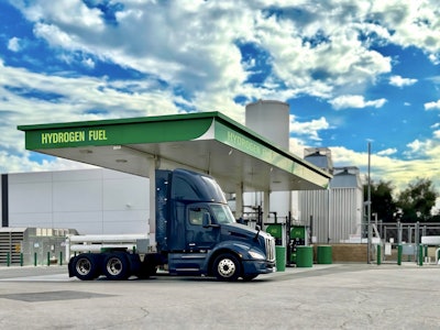 A hydrogen fuel cell Class 8 is shown at a green hydrogen refueling station.