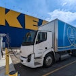 An IKEA Canada battery-electric delivery truck recharging outside a retail location.