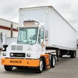 An example of an Orange EV electric yard tractor hauling a trailer.