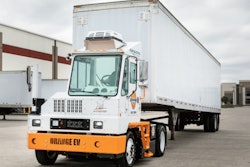 An example of an Orange EV electric yard tractor hauling a trailer.