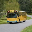 The new Thomas Built Type D battery-electric school bus, aka Wattson, driving down a neighborhood road.