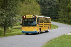 The new Thomas Built Type D battery-electric school bus, aka Wattson, driving down a neighborhood road.