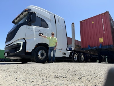 Bill Hall, owner of Port of Oakland-based Coyote Container, poses with his Nikola Tre FCEV semi.