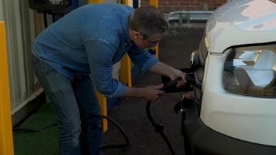 Family Laundry co-owner David Macquart-Moulin charges one of the company’s all-electric Ford E-Transit vans.