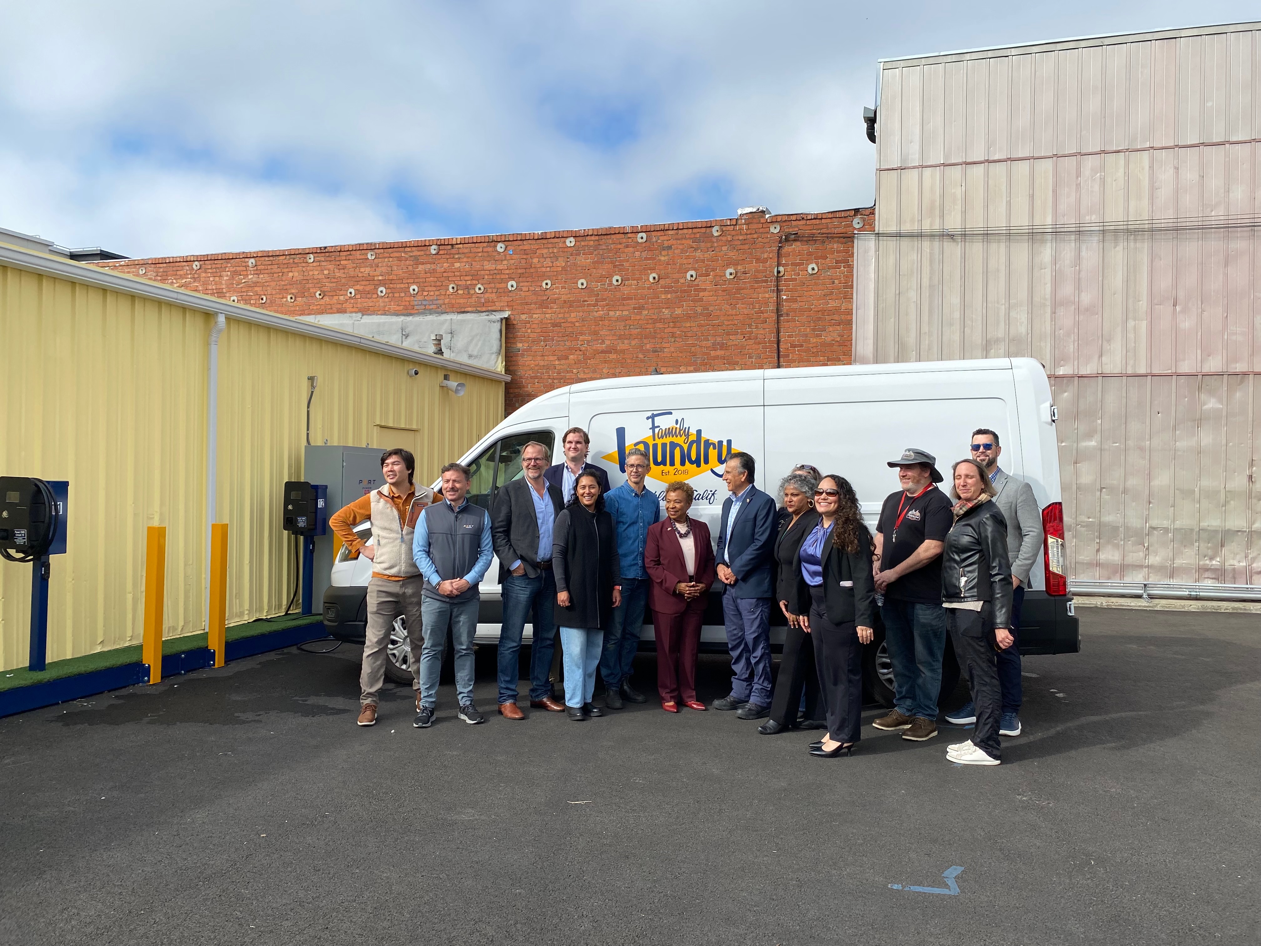 Port Power Founder and CEO Nadav Gur (second from left) poses Oakland Mayor Barbara Lee (center) with Family Laundry employees and city officials.
