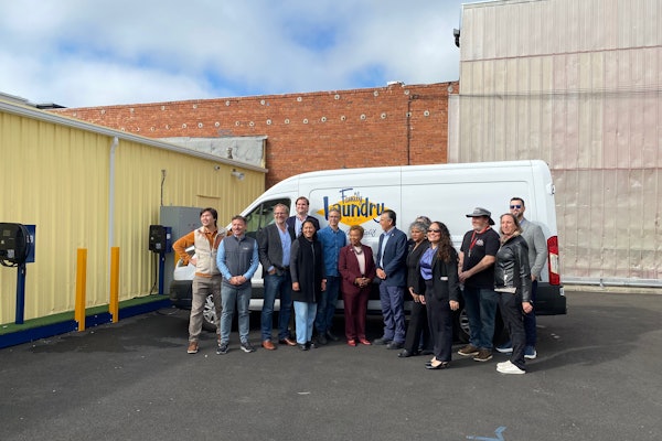 Port Power Founder and CEO Nadav Gur (second from left) poses Oakland Mayor Barbara Lee (center) with Family Laundry employees and city officials.