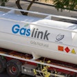A white Gaslink natural gas tanker truck shown parked on the roadside.