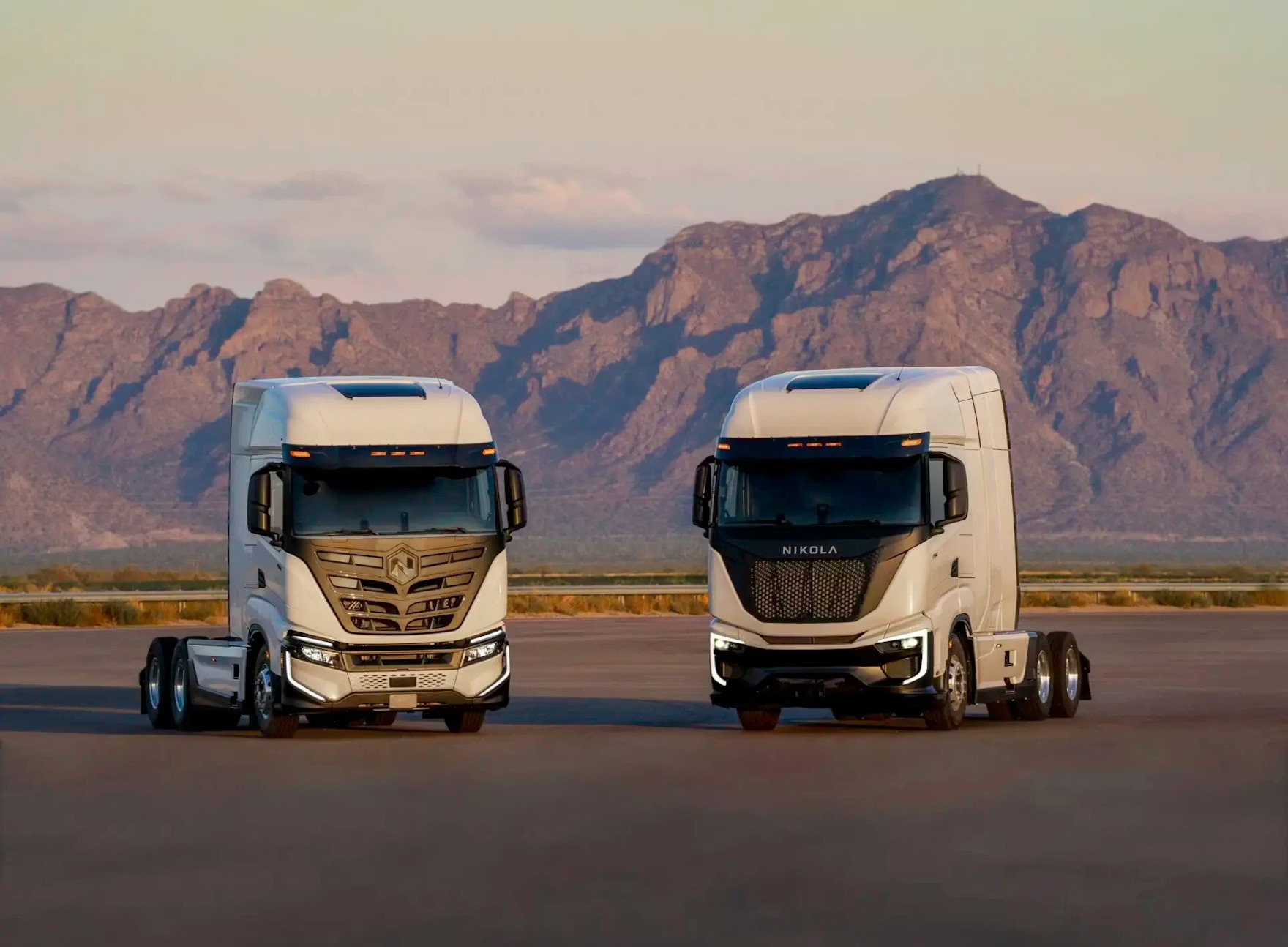 The Nikola BEV 2.0 (left) and Tre FCEV semi (right) parked outside for a publicity photo.