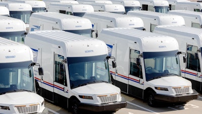 Examples of newly-manufactured Oshkosh Next Generation Delivery Vehicles (NGDV) parked in a USPS parking lot.