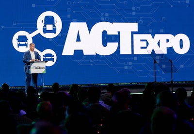 An unidentified individual speaking to an audience at the ACT Expo.