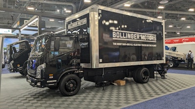 A black Bollinger B4 battery-electric Class 4 truck on display at ACT 2024.