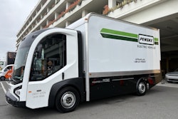 The battery-electric REE Automotive P7 Chassis Cab parked next to a building at the ACT Expo 2025.
