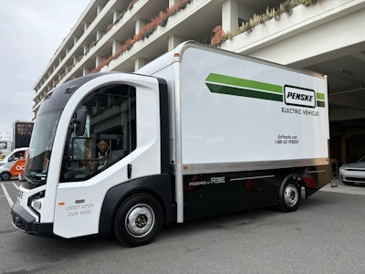 The battery-electric REE Automotive P7 Chassis Cab parked next to a building at the ACT Expo 2025.