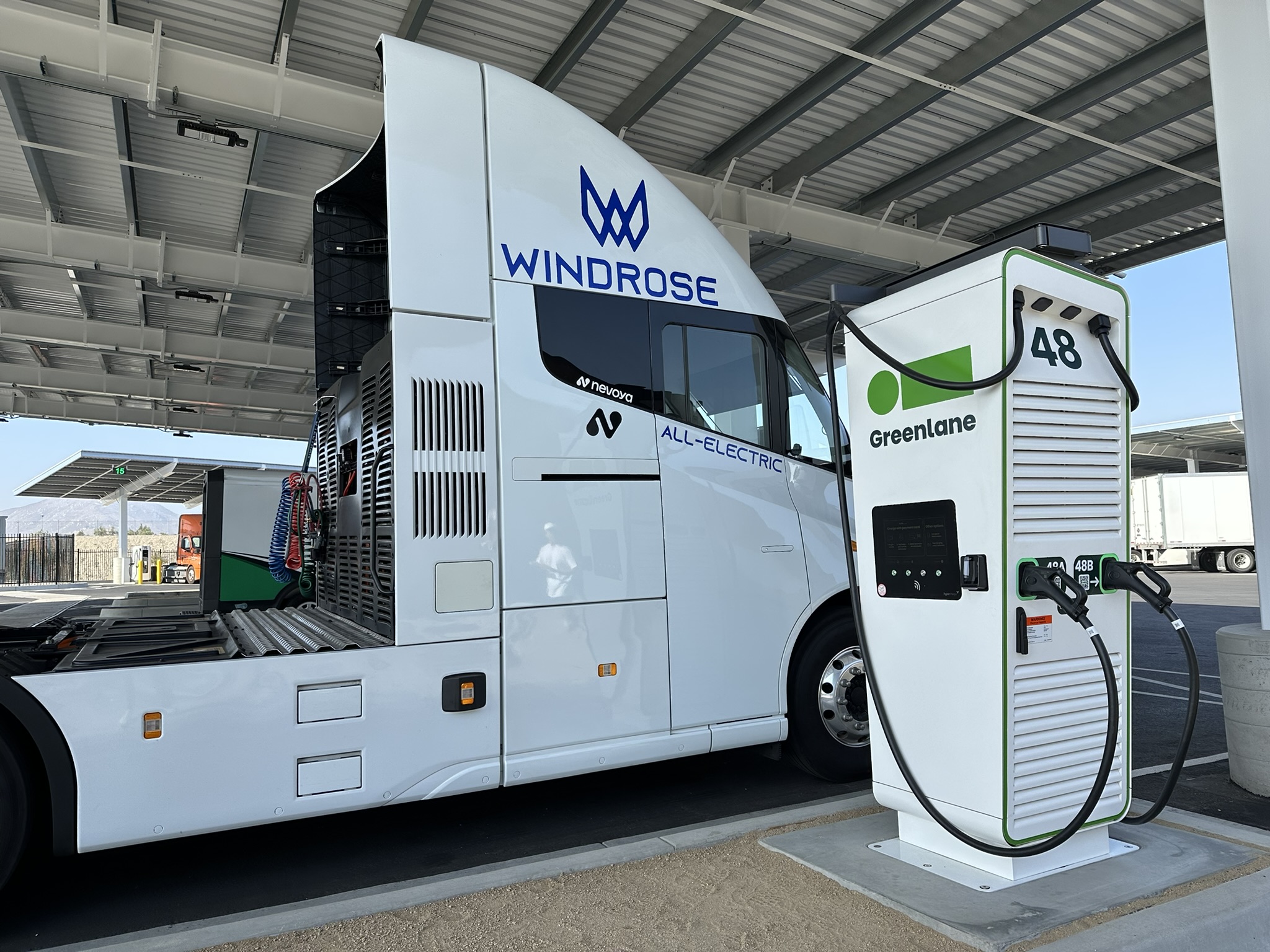 The Windrose Global E700 Class 8 battery-electric semi charging at a Greenlane charging station.