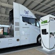 The Windrose Global E700 Class 8 battery-electric semi charging at a Greenlane charging station.