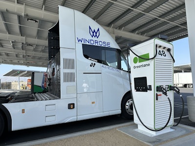 The Windrose Global E700 Class 8 battery-electric semi charging at a Greenlane charging station.